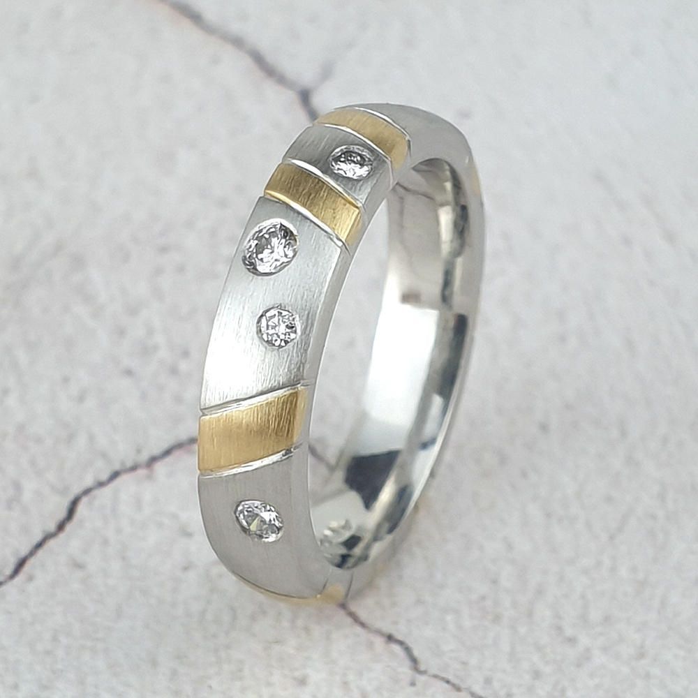 matte platinum wedding ring with yellow gold stripes and small diamonds