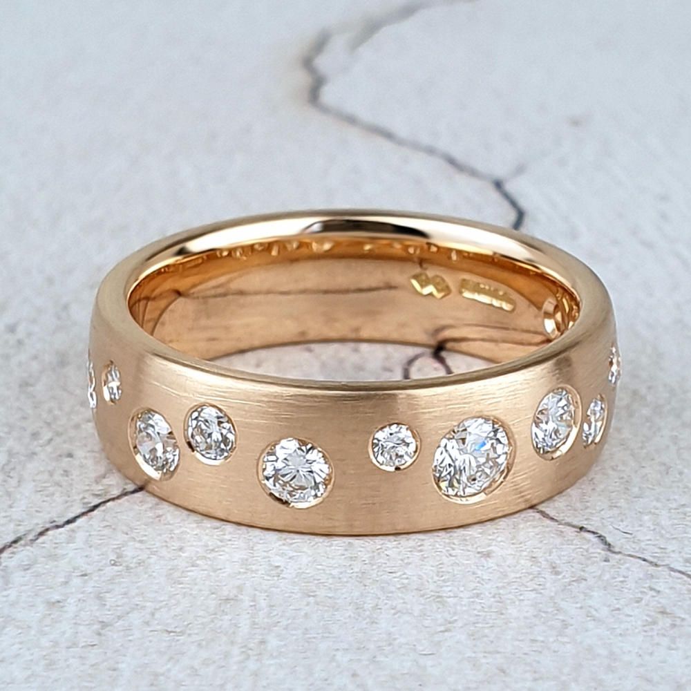 Red gold wedding ring with scattered diamonds