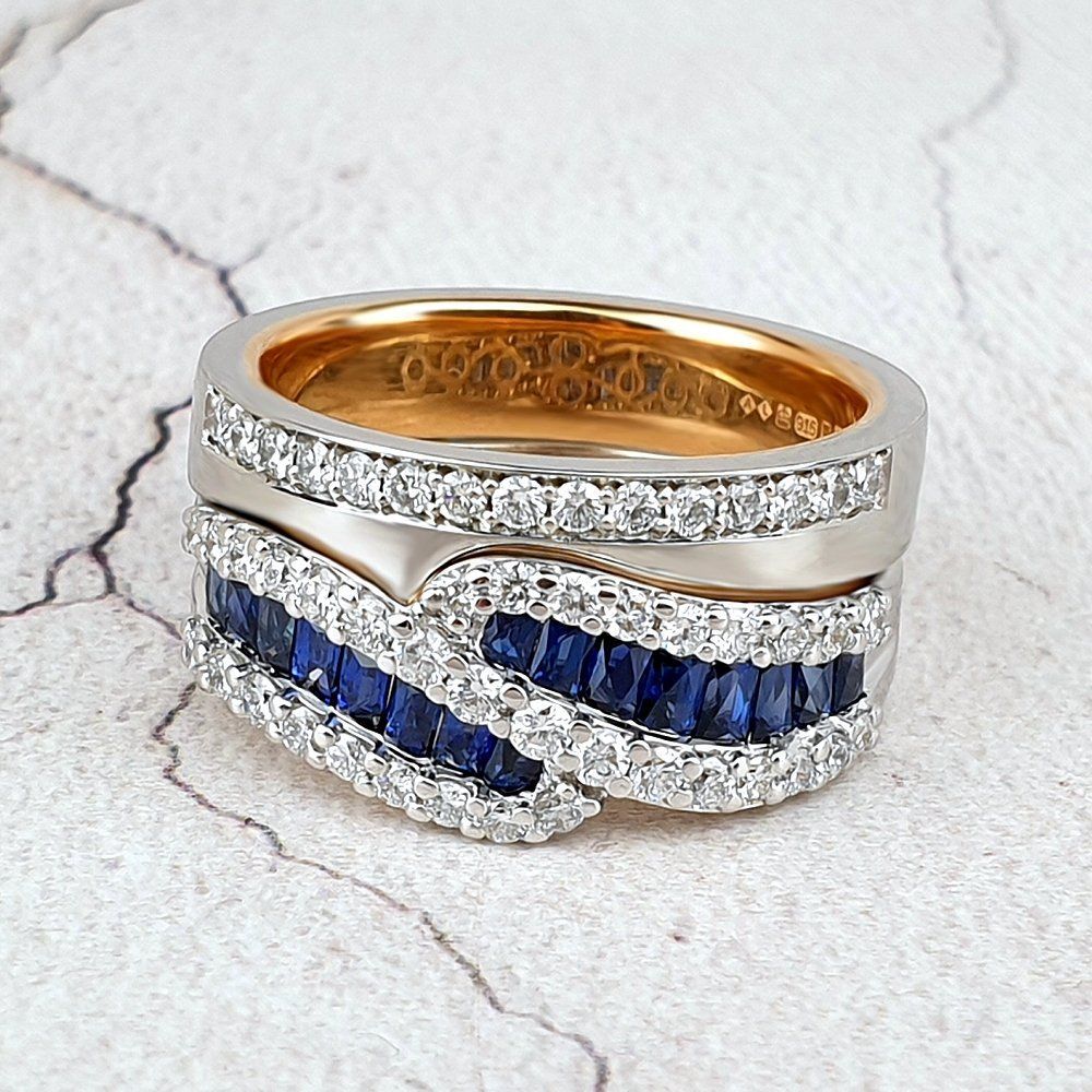 A custom fitted wedding ring shown with a sapphire and diamond engagement ring
