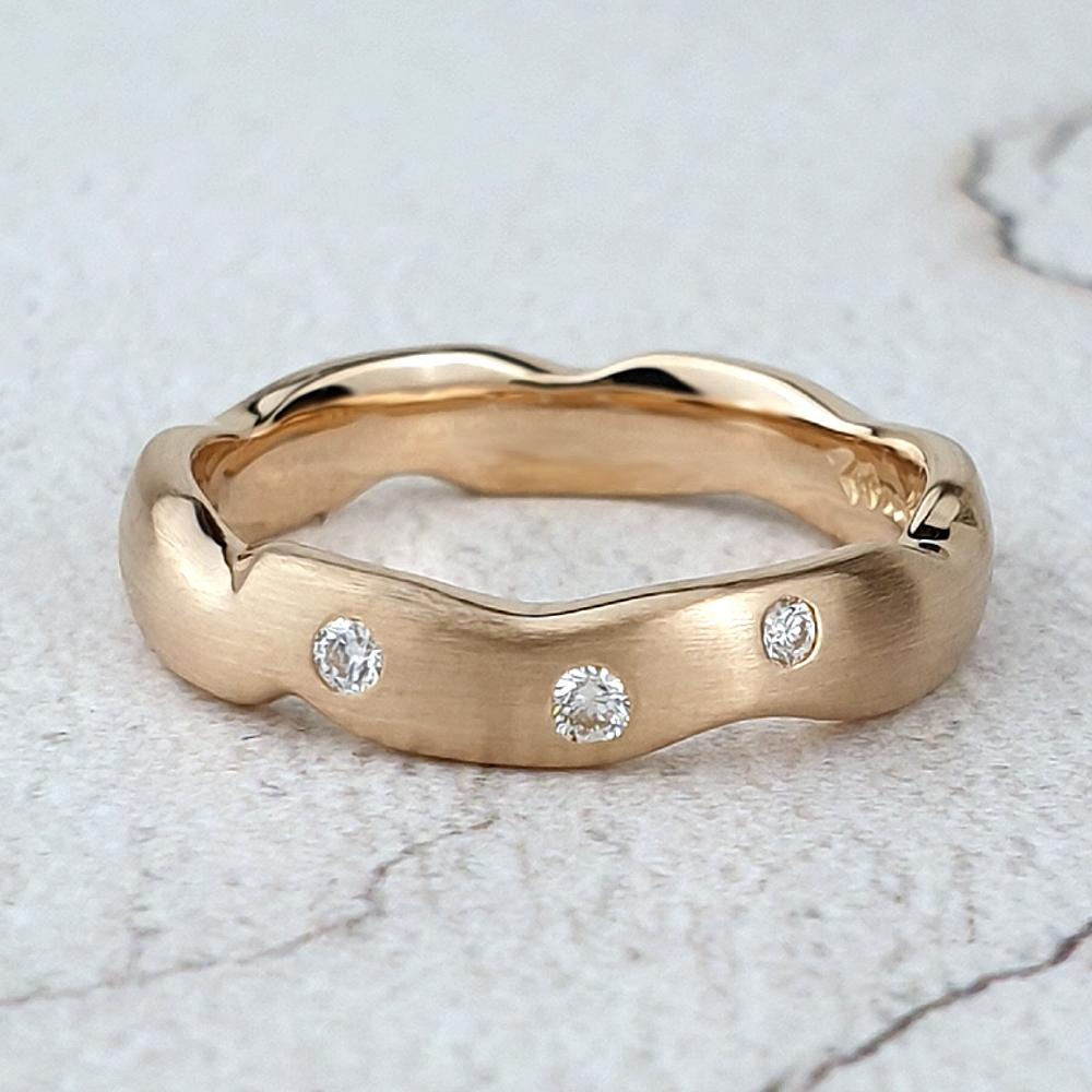 Carved red gold band with diamonds