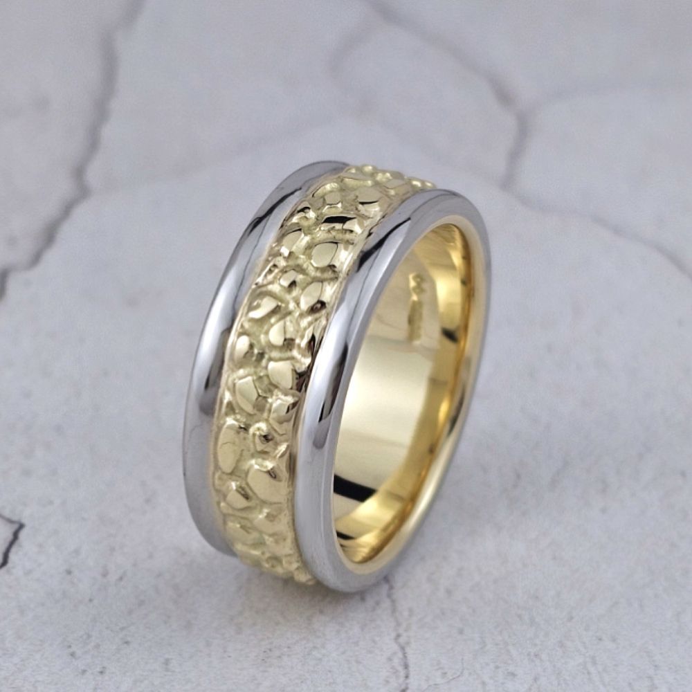 Man's wedding ring with nugget textured gold centre and plain platinum outer bands