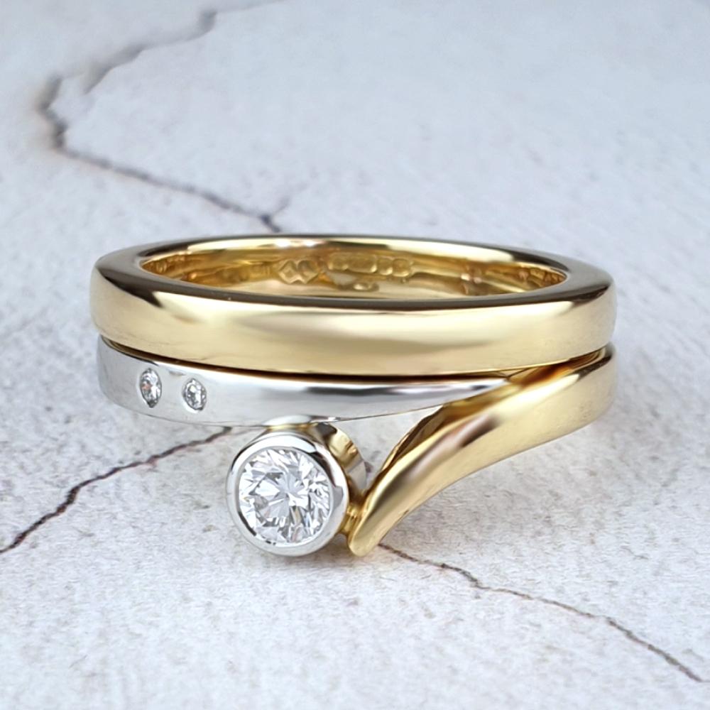 Platinum and gold Flick ring alongside gold wedding band