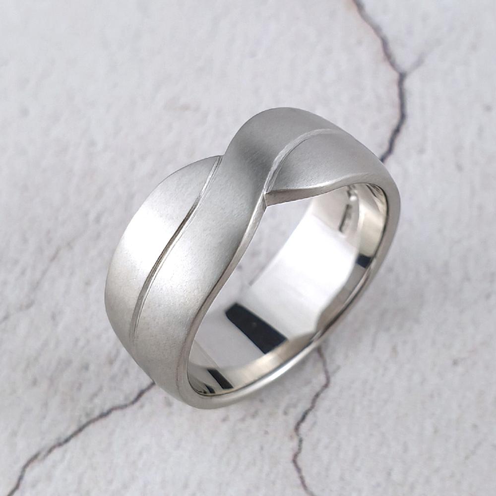 A man's platinum wedding band with a crossover effect
