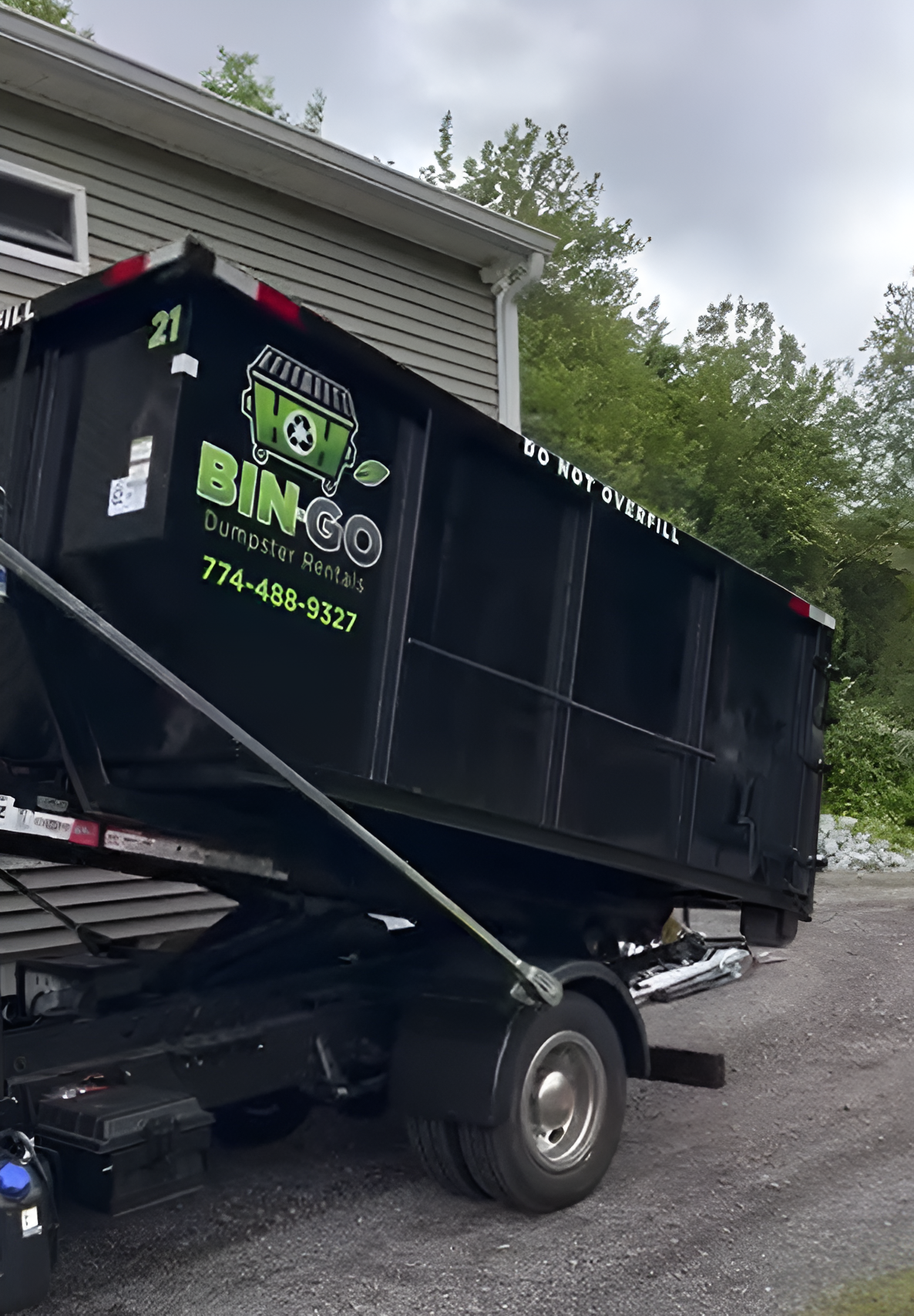 A large black dumpster, labeled