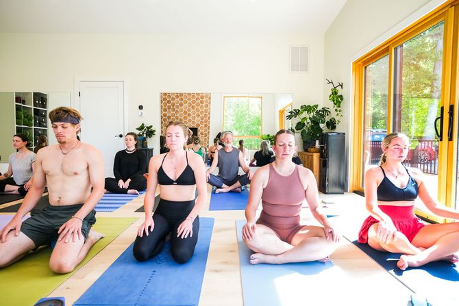bachelorette party in the yoga barn doing tree pose and holding hands leaning on each other having fun!