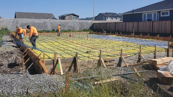 Contractors pouring concrete foundation