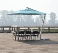 Patio deck with black wicker seating, red cushions, fire pit table, and large umbrella