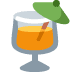 Orange drink in a tilted cocktail glass with a green umbrella and lemon slice