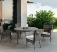 Covered patio with lime-green sectional sofa, red patterned rug, and dark wicker coffee table