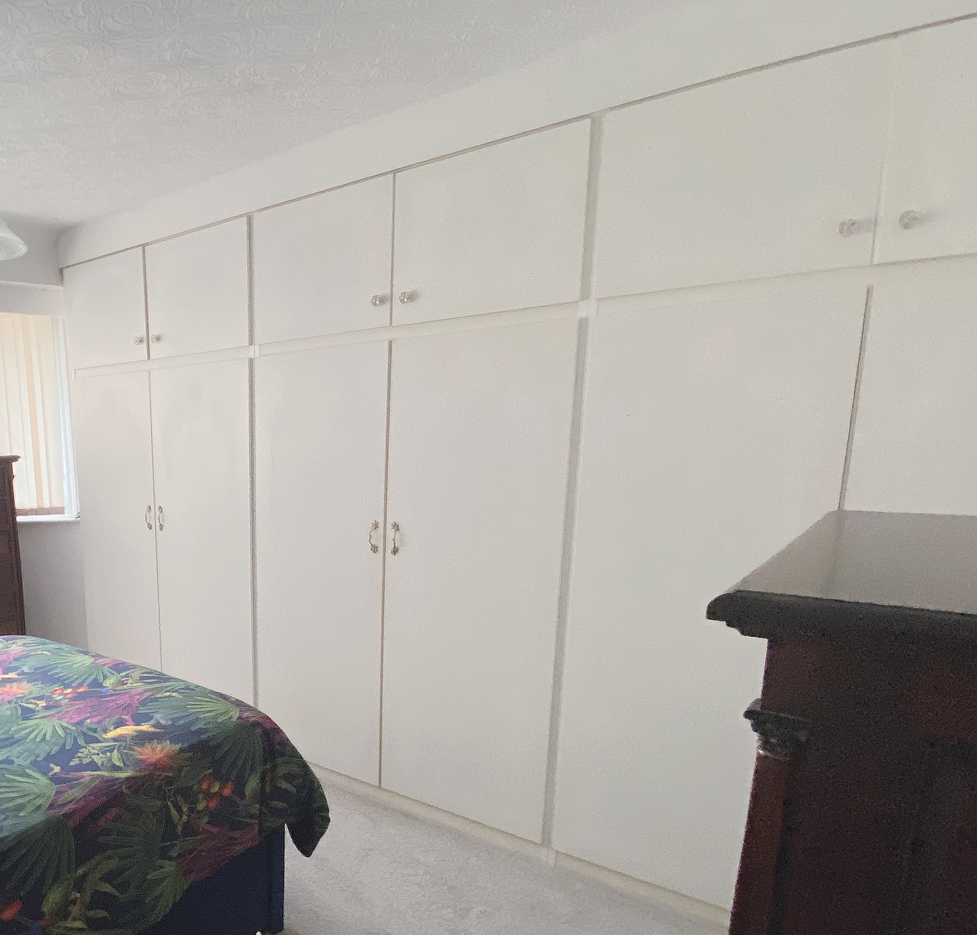 Existing wardrobes in white before refit.