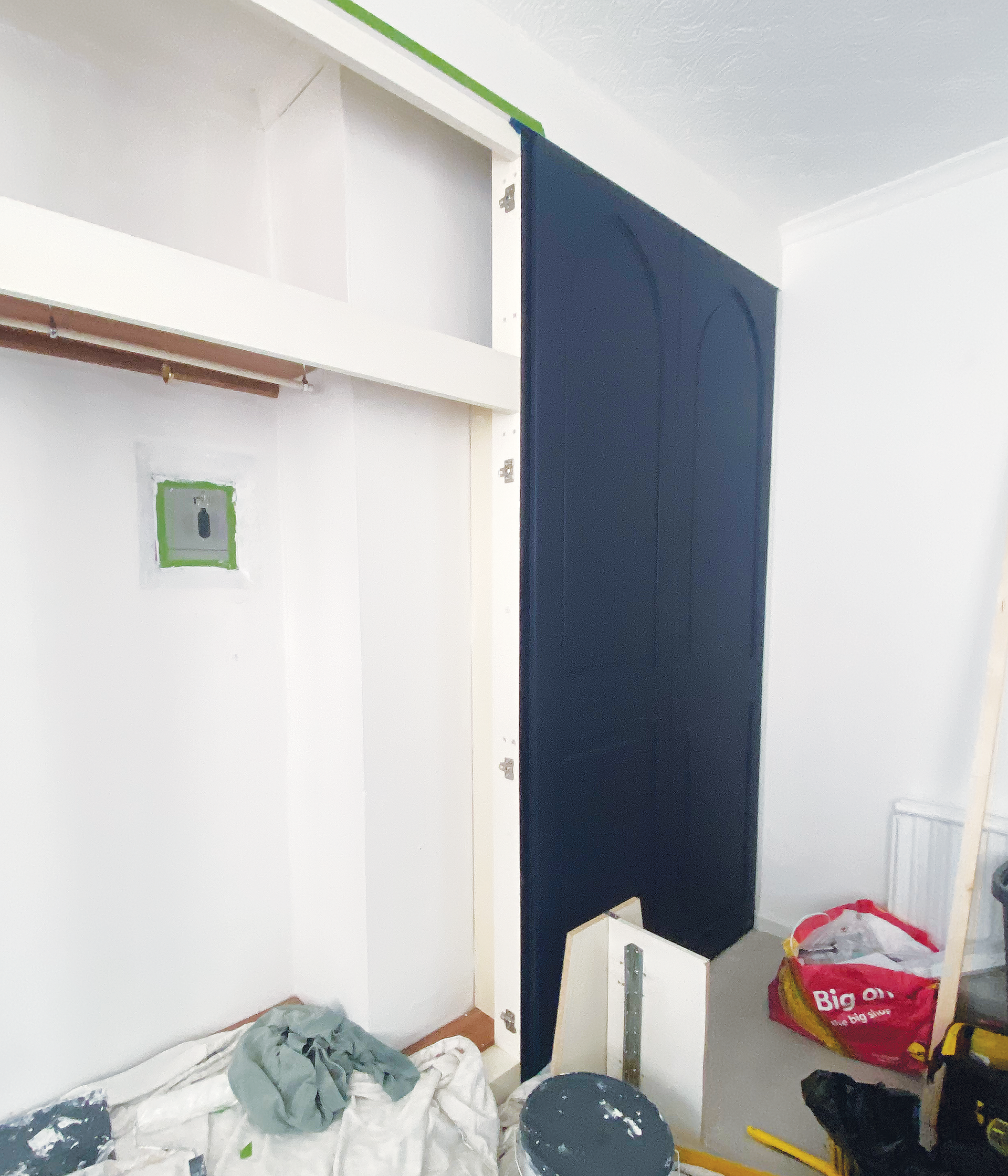 First of the new dark blue doors being hung on the framework