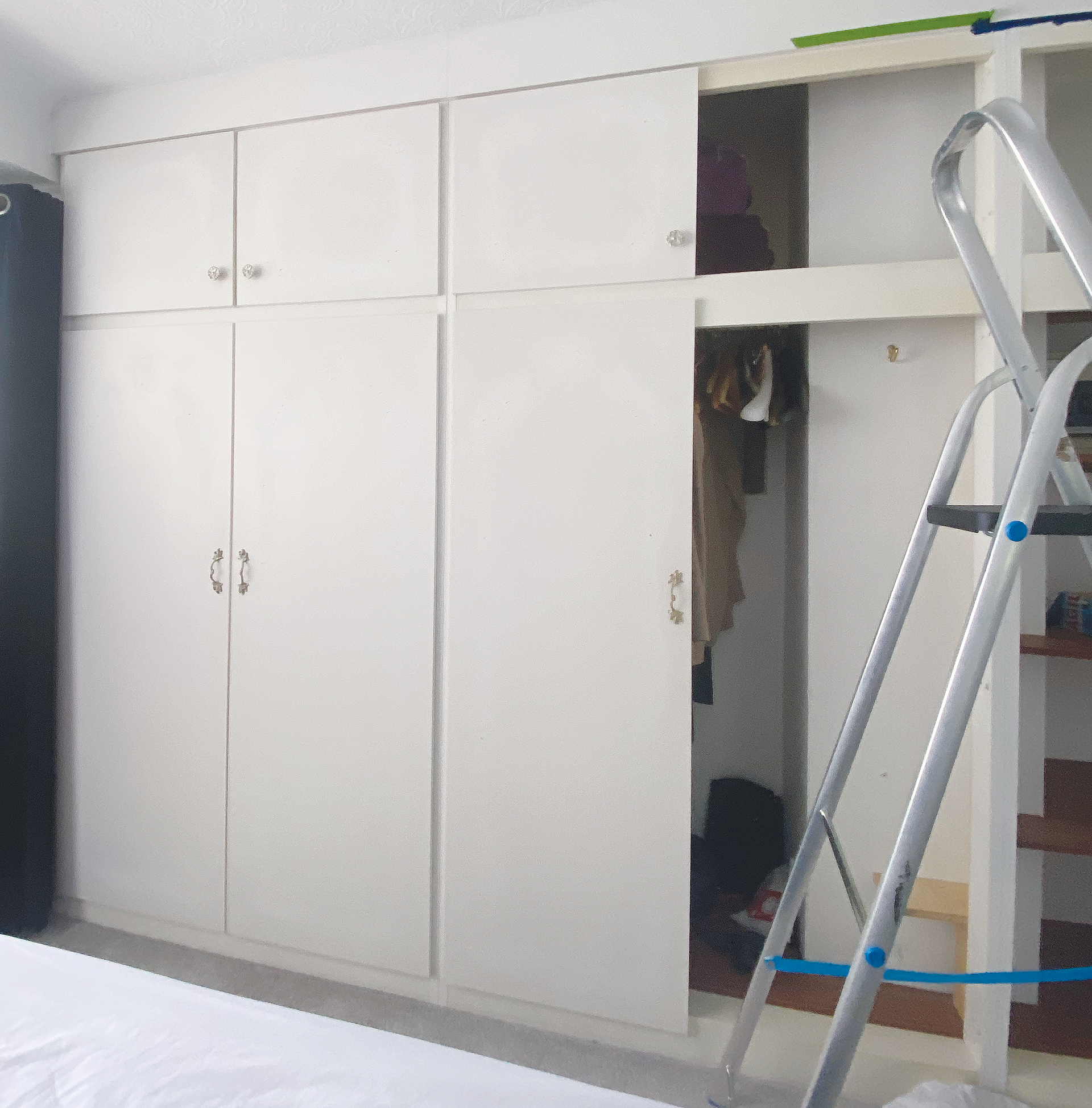 Wardrobes in white being dismantled.