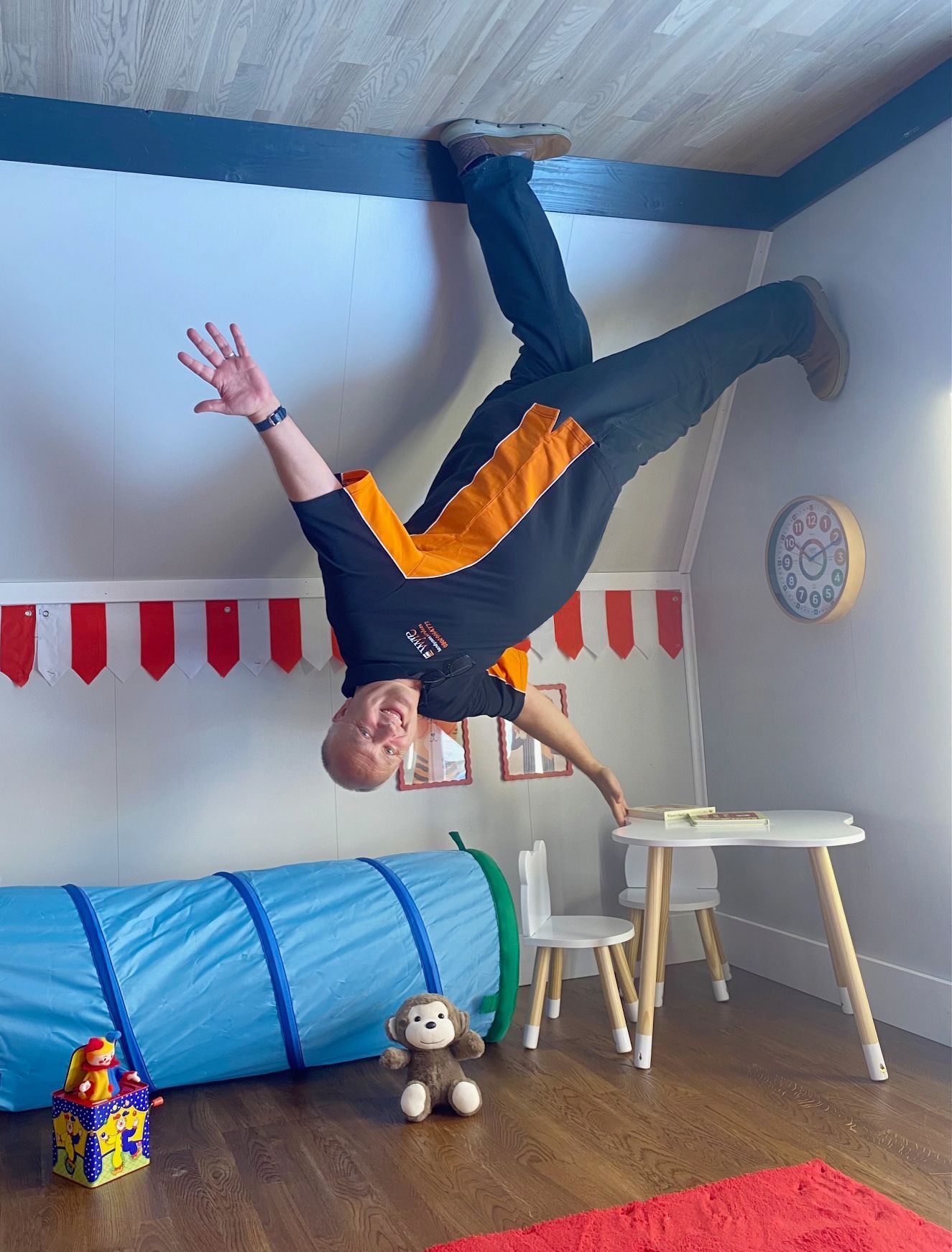 paul balancing on a child's table upside down