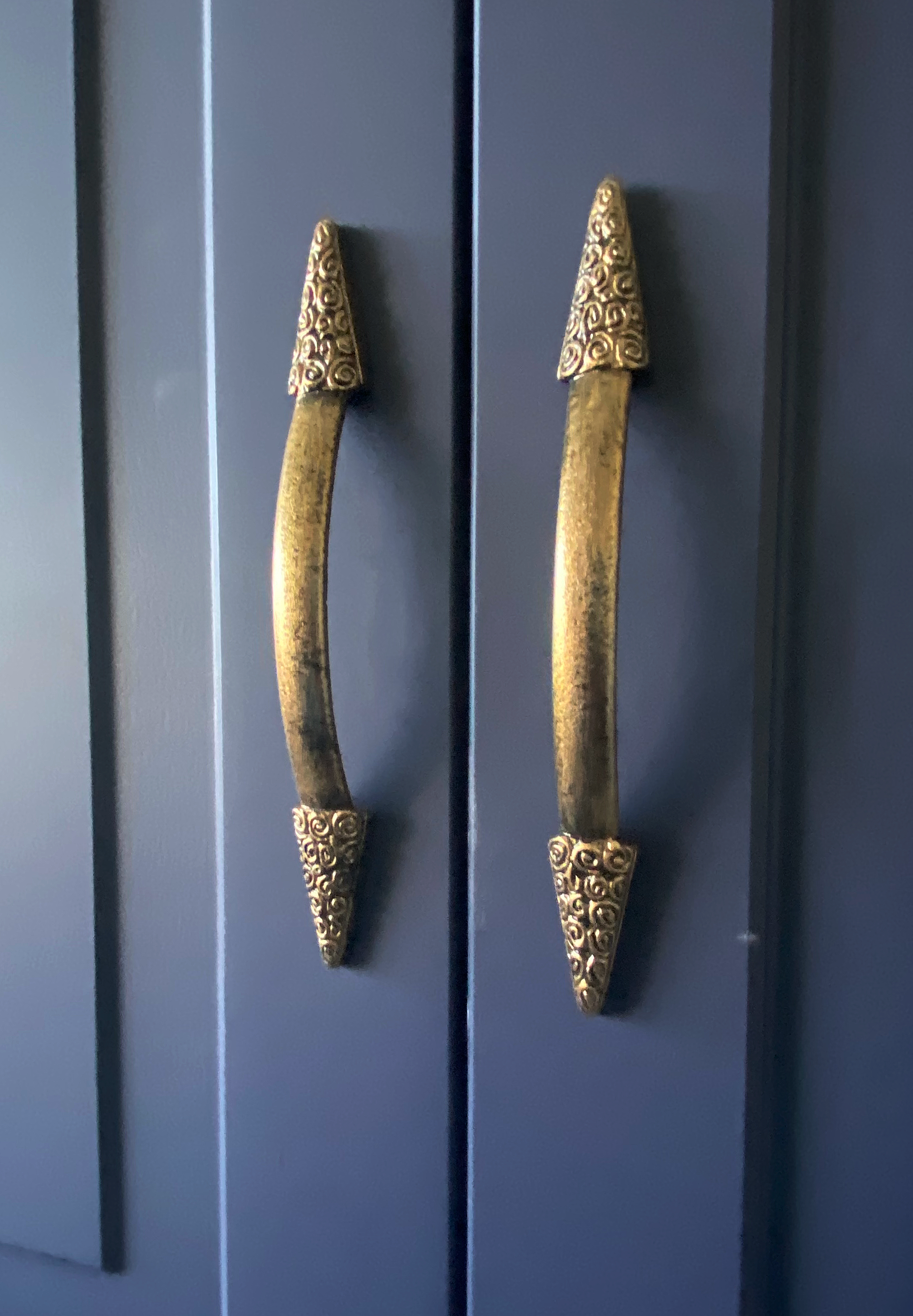 Handles after custom painting to give an aged metal effect, including fake pitting.