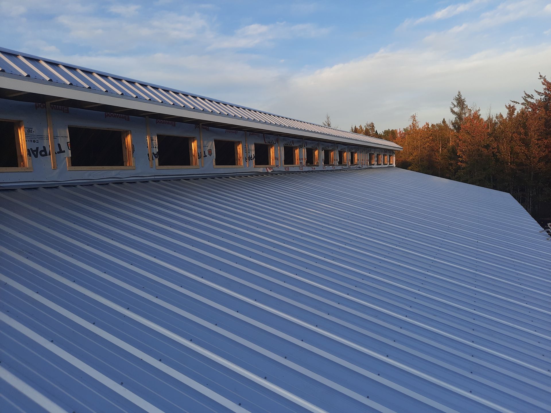 A large metal roof with a blue sky in the background