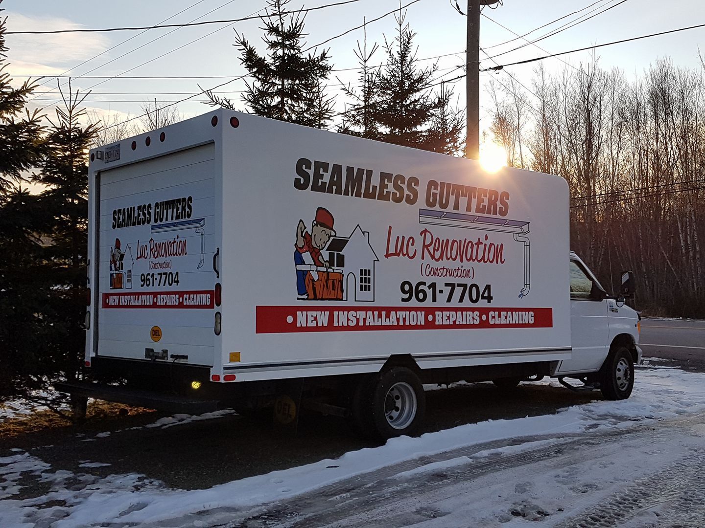 A seamless gutters truck is parked in the snow