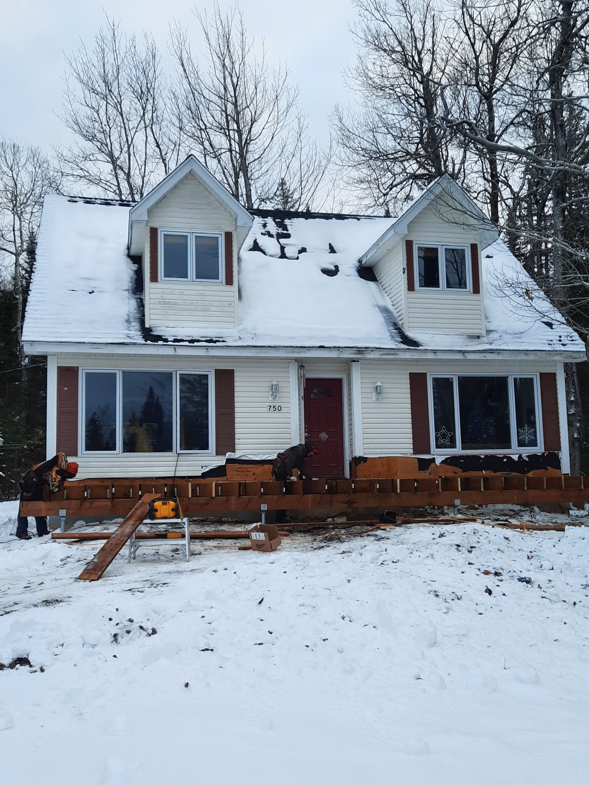 A house that is being built in the snow