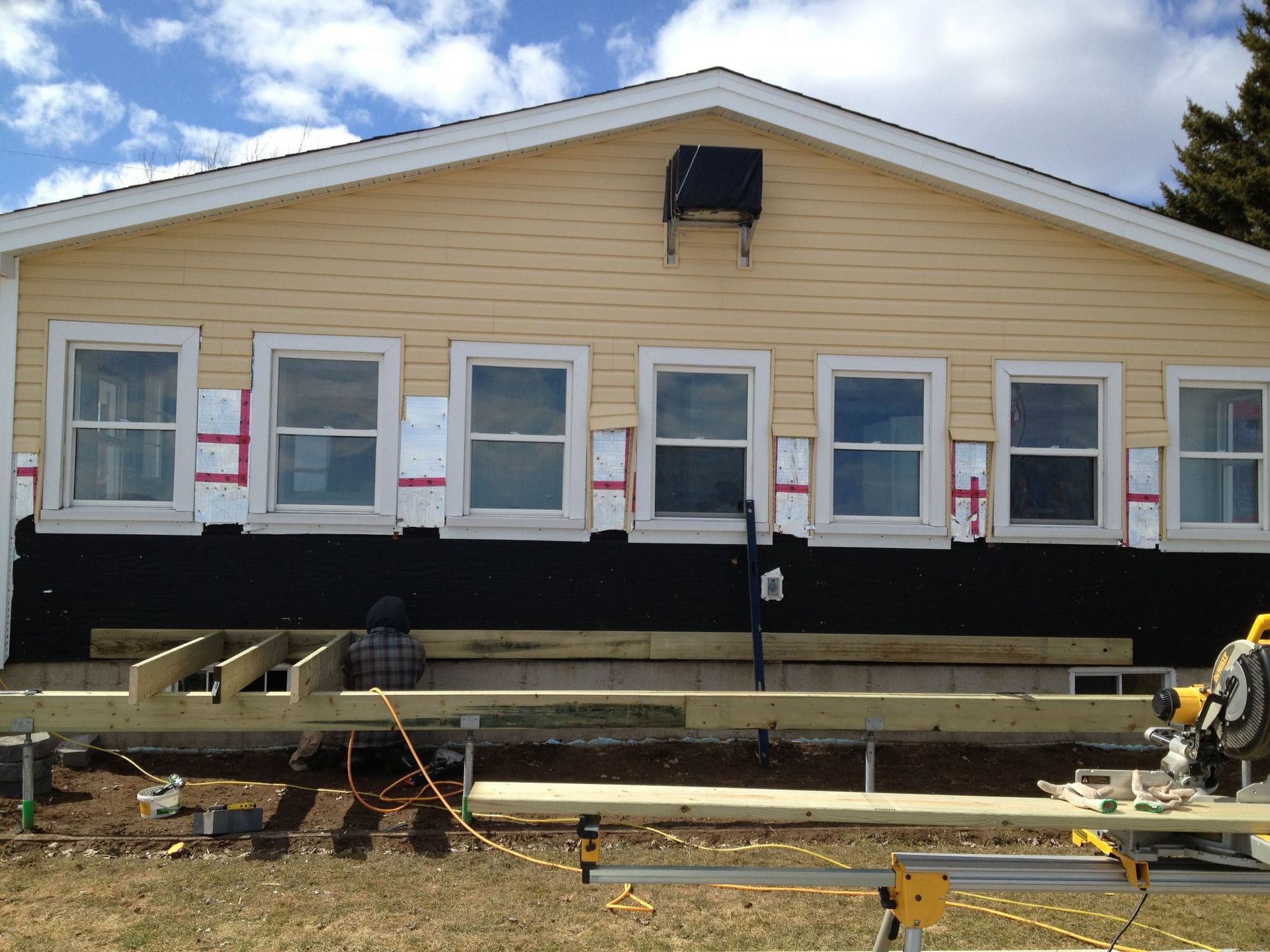 A house with a lot of windows is being remodeled