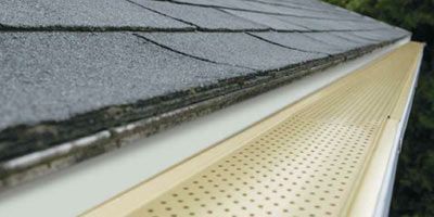 A close up of a gutter on the side of a roof.