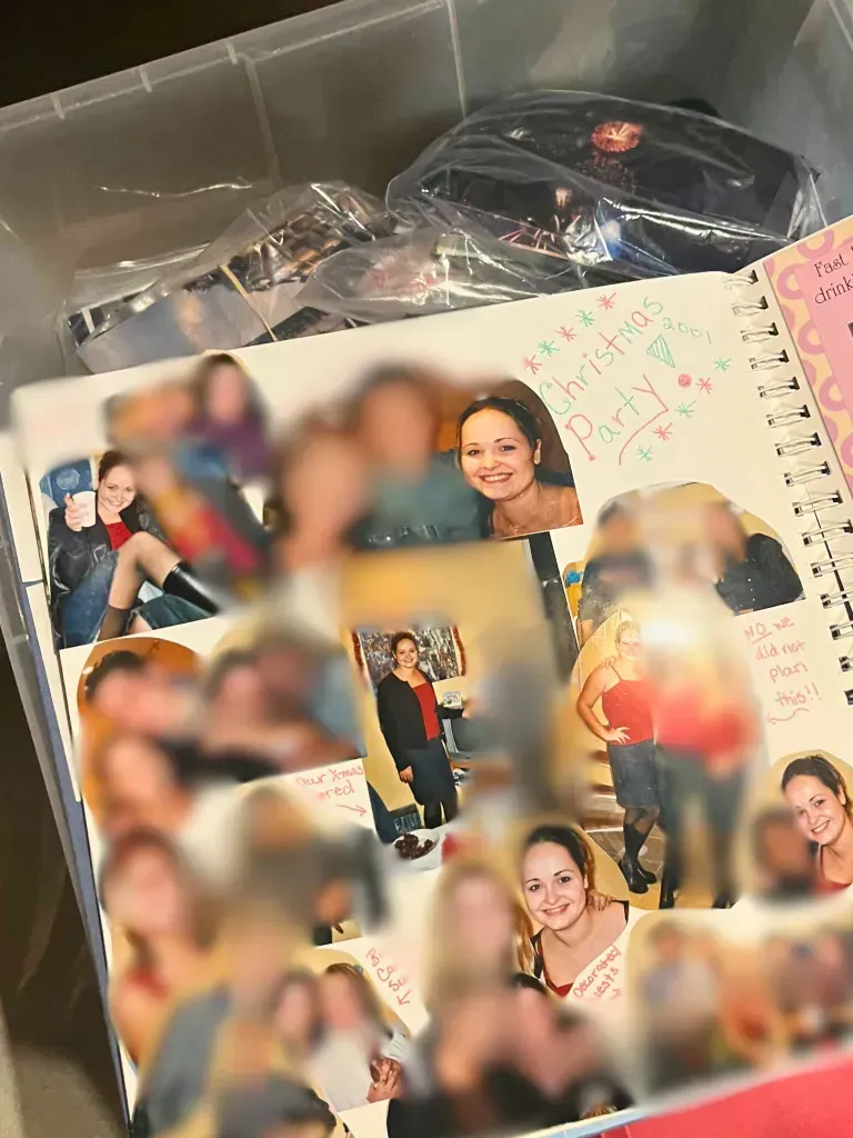 A box filled with a bunch of pictures including a birthday card