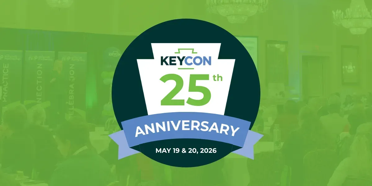 A logo for KeyCon 25th Anniversary on May 19 & 20, 2024, featuring a keystone-shaped design over a blurred event background.