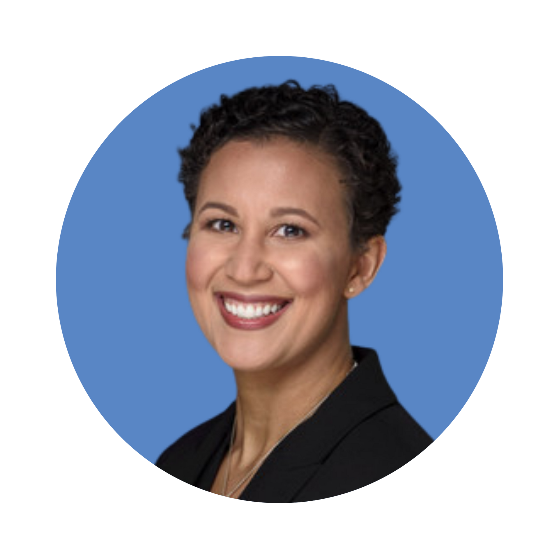 Smiling portrait of a person in a black blazer against a blue background