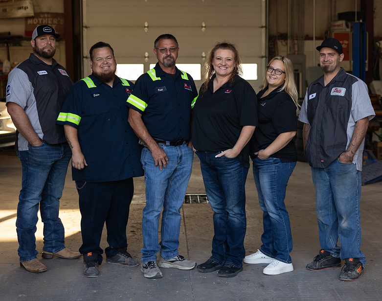 Our team posed in front of our garage in Hastings, NE | Pat's Auto Repair & Towing