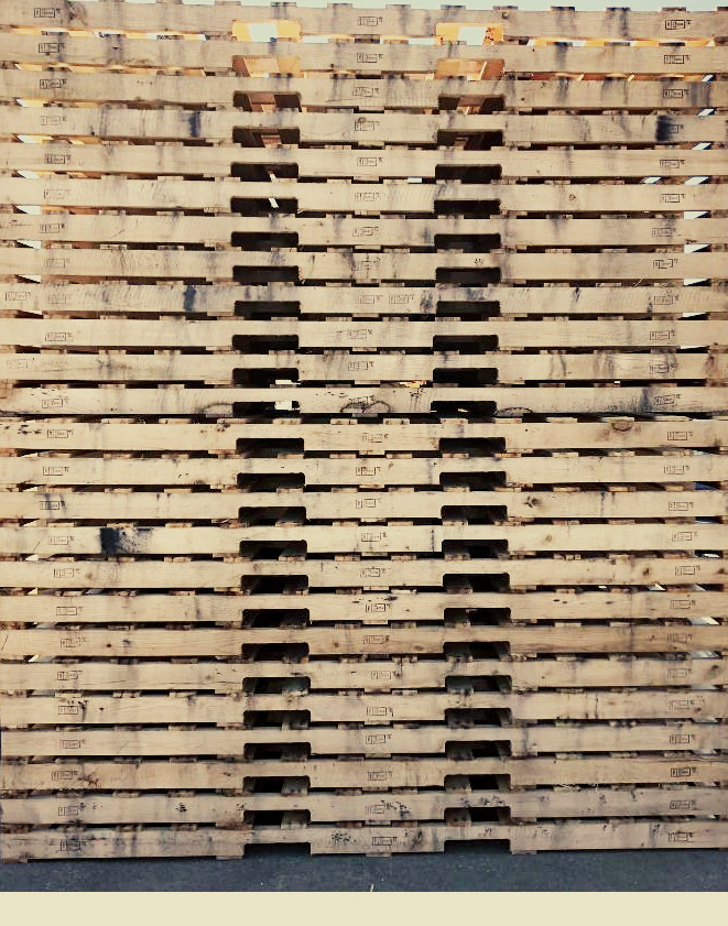 Standard new wood pallets stacked at Delisa Pallet facility Middlesex NJ