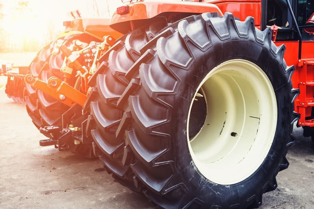 A Row Of Tractor Tires Are Sitting Next To Each Other In A Parking Lot — Leslie Farm & Garden Machinery In South Grafton, NSW