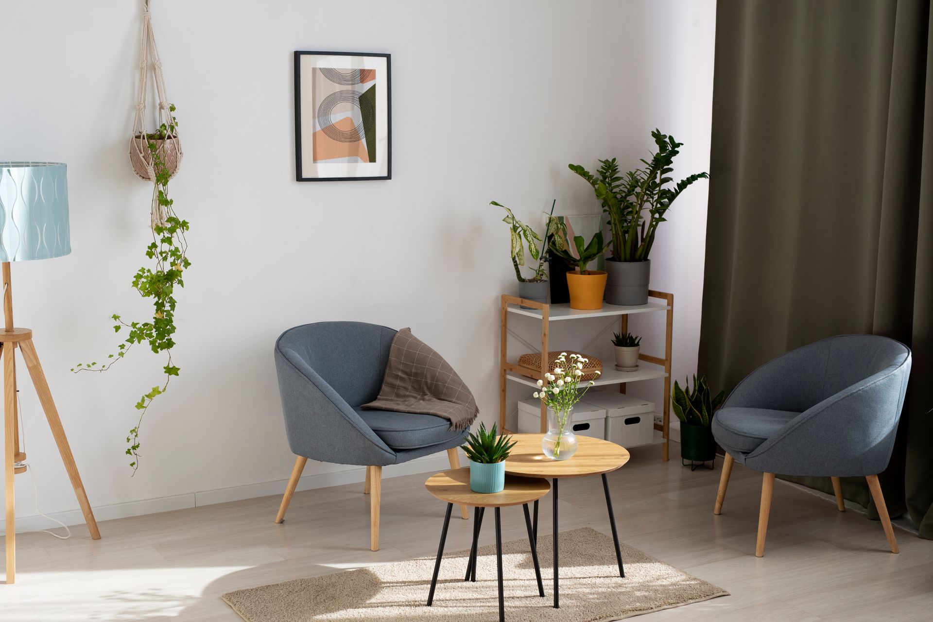 Cozy living room with two blue armchairs, small wooden coffee table, and plants.