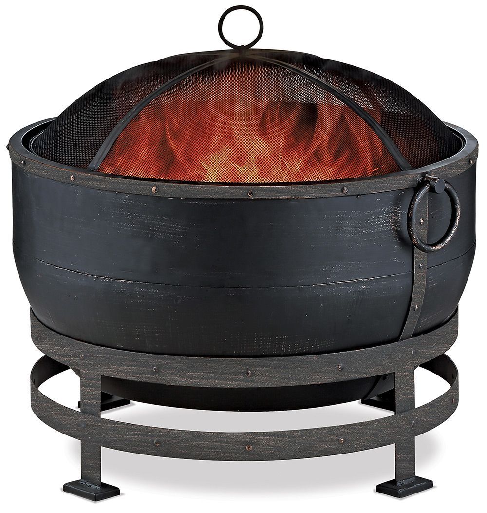 Black round fire pit with a dome lid and orange flames inside on a metal stand