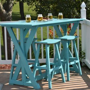 Turquoise outdoor bar table with stools and drinks on a sunny porch behind a white fence