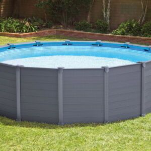 Round above-ground pool with gray exterior and blue water in a grassy backyard