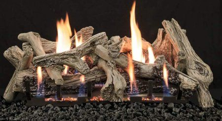 Gas fireplace with stacked ceramic logs and tall orange flames on a black grate