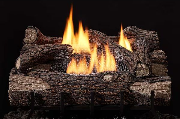 Flaming logs in a rustic fireplace grate with bright orange flames