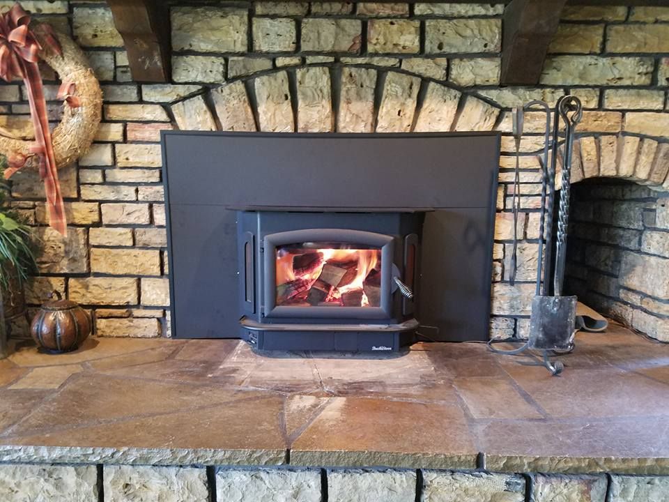 A Fire Burning In A Wood Stove Insert.