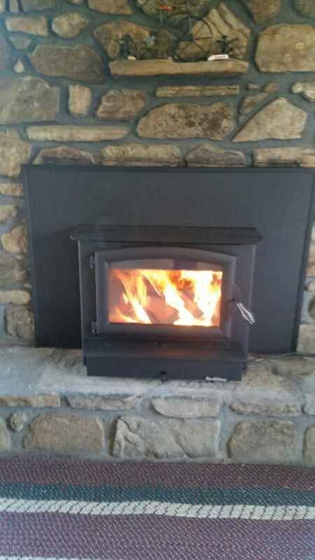 Wood Stove Burning In Fireplace.