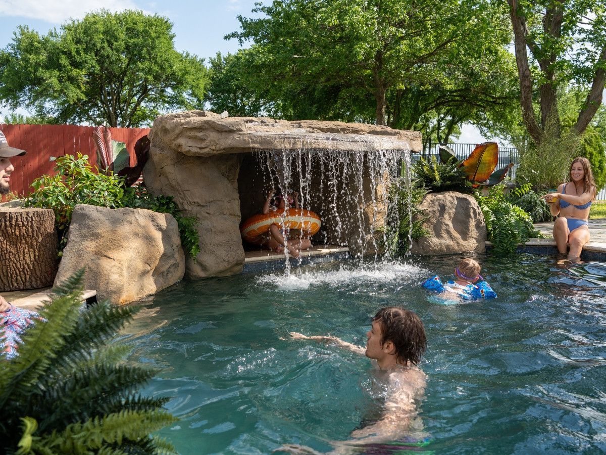Sunset Grove Grotto Waterfall with coping edge that extends into the pool. This swimming pool waterfall comes in ONE piece.