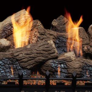 Flames rising from stacked logs in a fireplace with a black metal grate