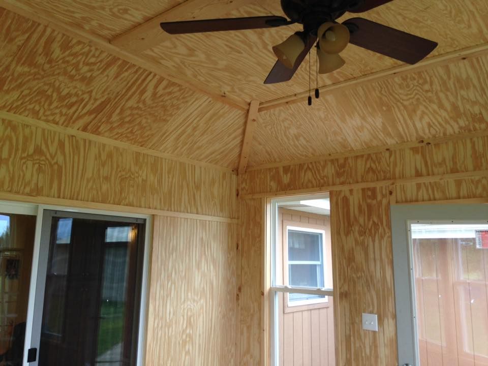 A room with a ceiling fan and a window