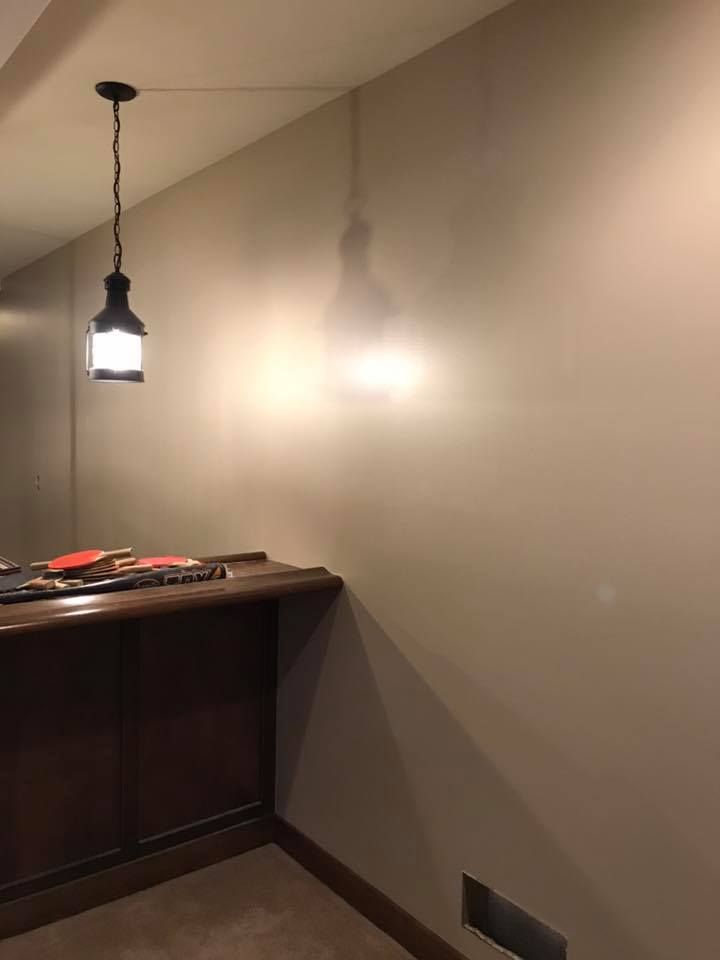 There is a light hanging from the ceiling in the room.