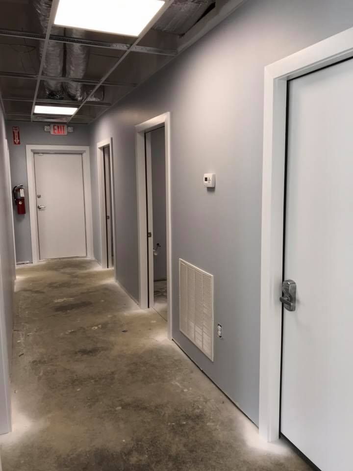 A long hallway with a fire extinguisher on the wall