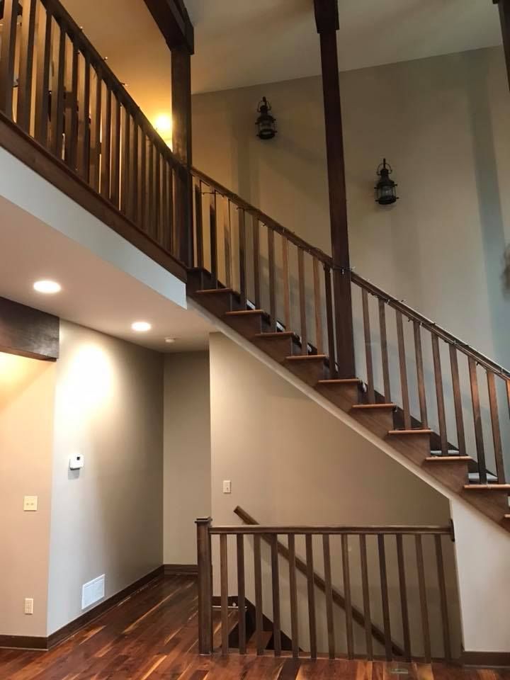 A staircase in a house with a wooden railing