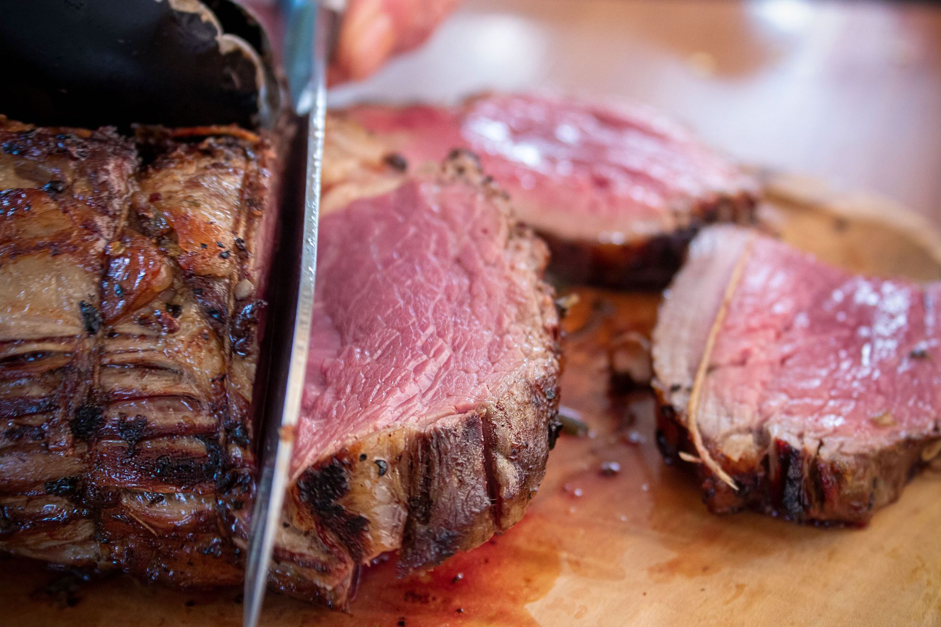 Red and black butcher ad for bulk Angus beef boxes, with prices, phone number, and steak, roast, and ground beef photos