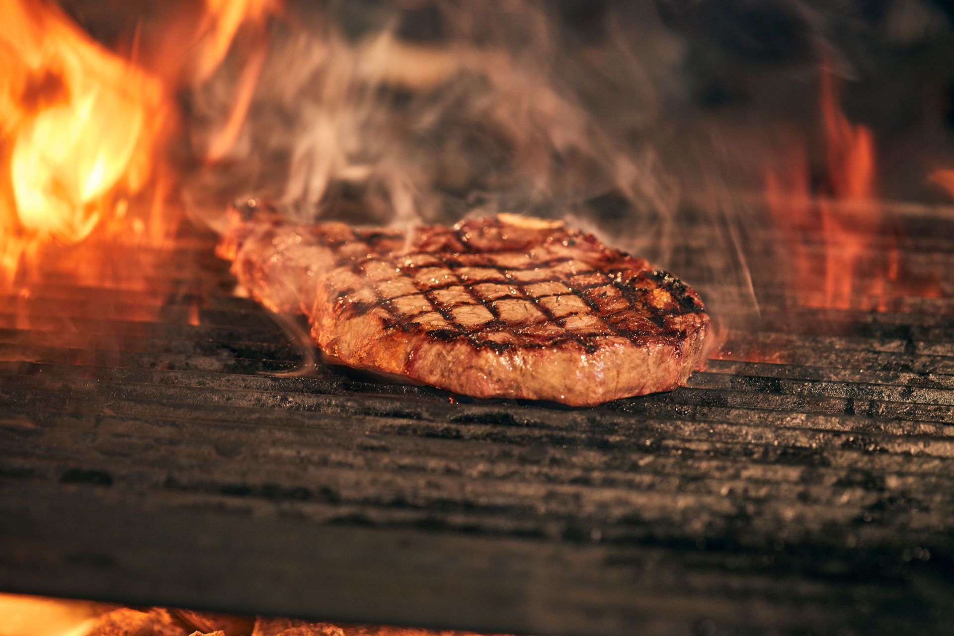Red and black butcher ad for bulk Angus beef boxes, with prices, phone number, and steak, roast, and ground beef photos