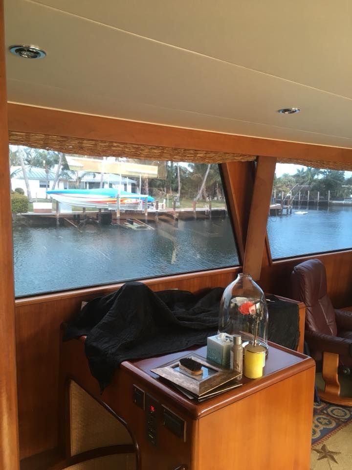 A room with a table and chairs and a window overlooking a body of water.