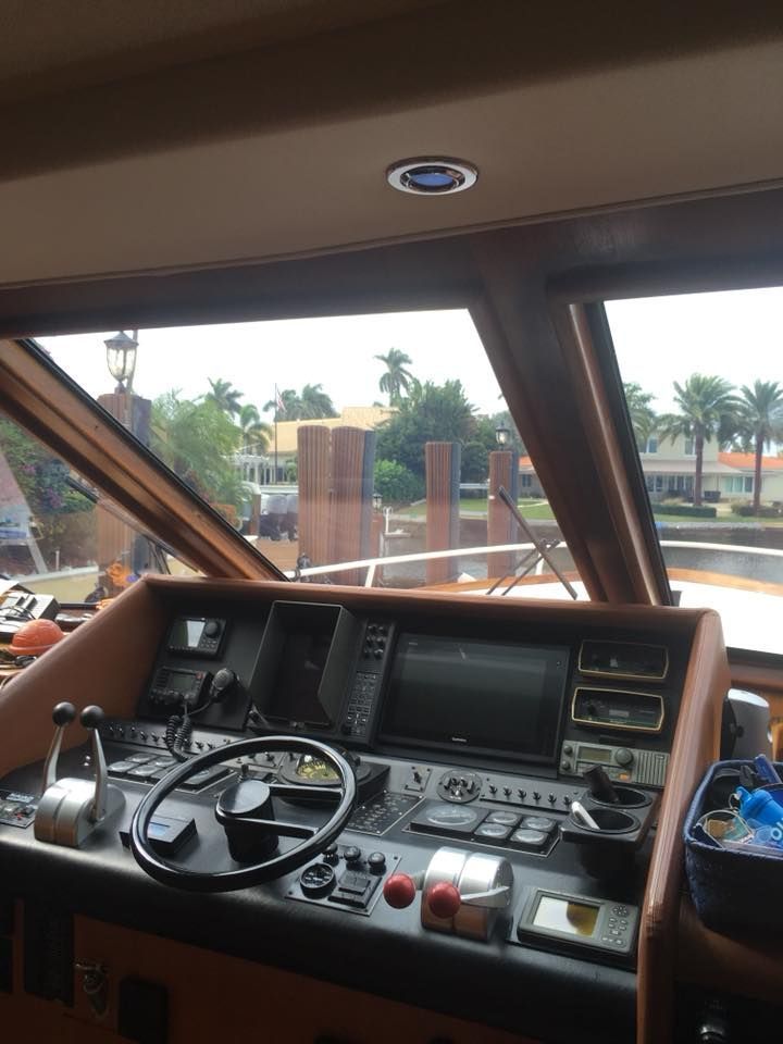 A boat 's cockpit with a steering wheel and a monitor