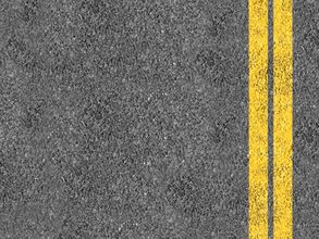 Asphalt road surface with two yellow center lines on the right