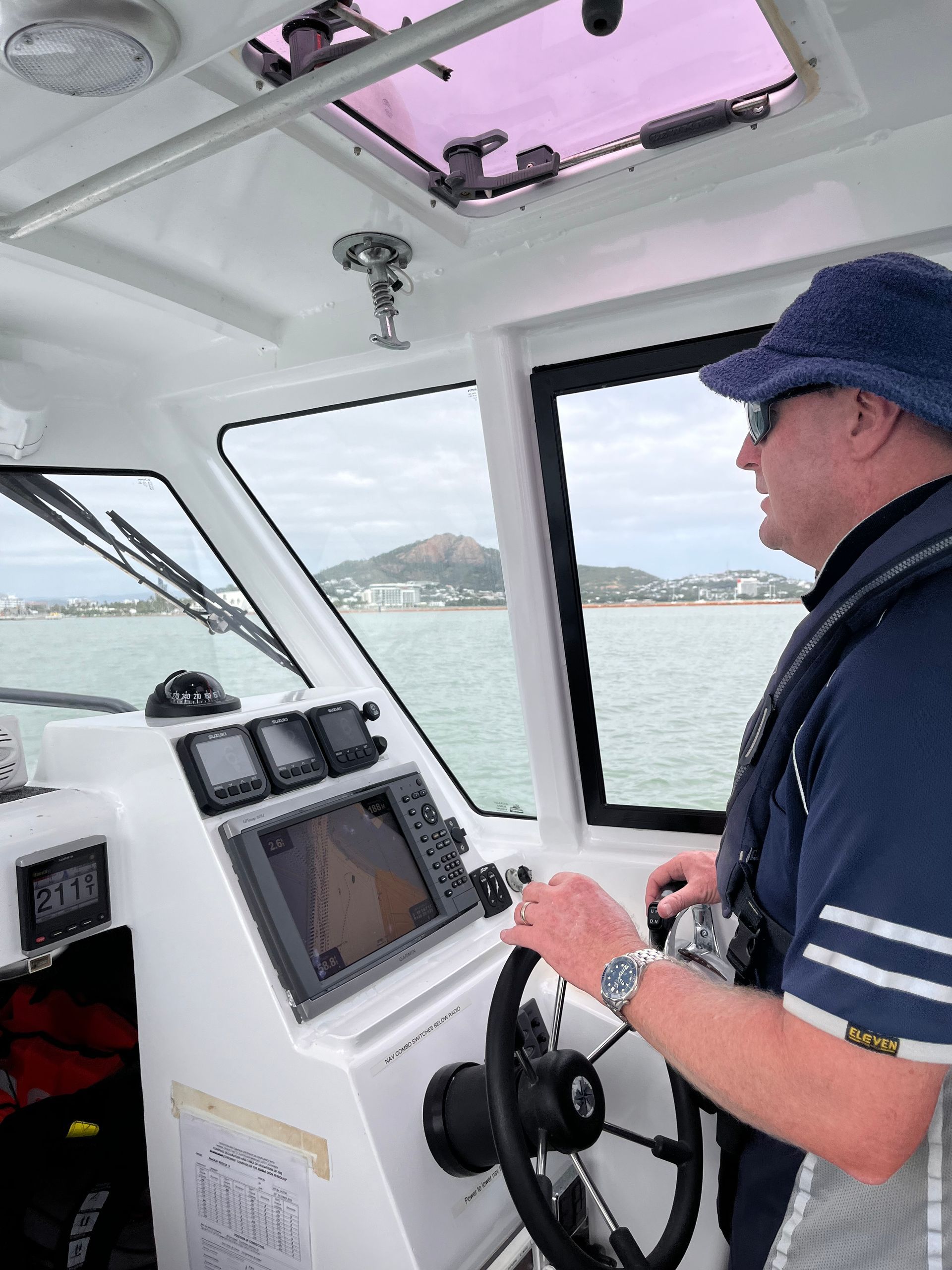 Man Cleaning Side of Boat - Boat Transportation in South Townsville, QLD Man Cleaning Side of Boat - Boat Transportation in South Townsville, QLD
