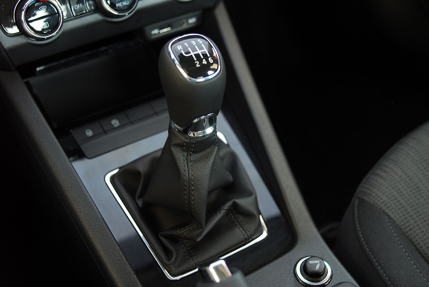 Manual transmission gear shifter inside a car center console